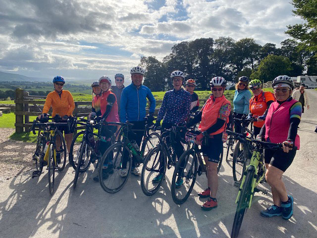 An image of a group of Halcyon cyclists standing with their bikes.