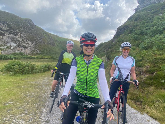 An image of cyclings near some hills.