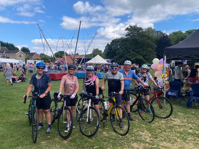 An image of a group of cyclists at an event.